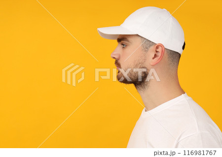 A young guy in a white T-shirt and a white cap 116981767