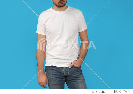 A young guy in a white t-shirt on a blue background 116981769