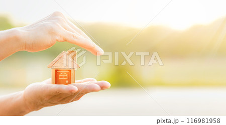 Man protecting house model on table. planning savings money of coins to buy a home concept, concept for property ladder, mortgage and real estate invest. Man protecting house model on table. planning savings money of coins to buy a home concept, concept for property ladder, mortgage and real estate invest. 116981958