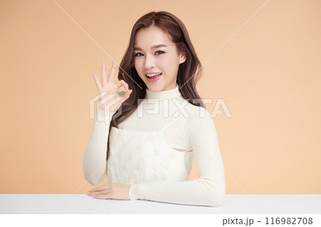 Beautiful young asian woman with clean fresh skin on beige background, Face care, Facial treatment, Cosmetology, beauty and spa, Asian women portrait. 116982708