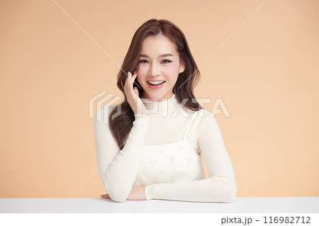 Beautiful young asian woman with clean fresh skin on beige background, Face care, Facial treatment, Cosmetology, beauty and spa, Asian women portrait. 116982712