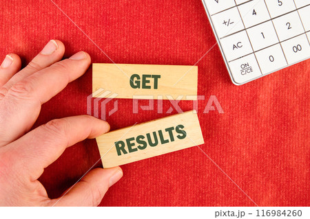 GET RESULTS text written lettering on wooden blocks on a red background GET RESULTS text written lettering on wooden blocks on a red background 116984260