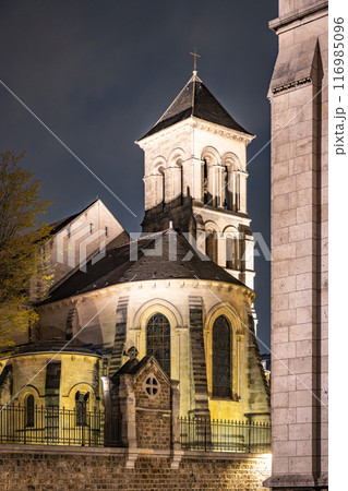 The Church of Saint-Pierre de Montmartre is illuminated under the night sky, showcasing its architectural beauty in Paris, France. 116985096