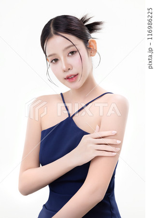 Beautiful young Asian woman with K beauty style makeup and perfect skin using lotion on isolated white background. Facial and skin care concept for commercial advertising. 116986225
