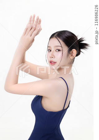 Beautiful young Asian woman with K beauty style makeup and perfect skin using lotion on isolated white background. Facial and skin care concept for commercial advertising. 116986226