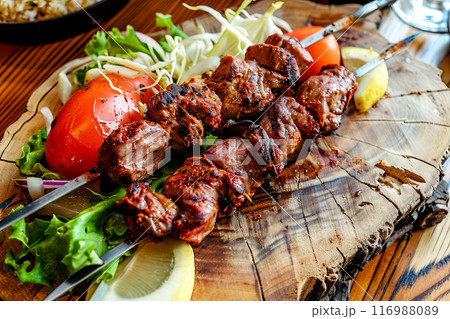 A popular Turkish dish, shashlik is a Middle Eastern dish that is cooked over charcoal using pieces of meat threaded onto skewers. A popular Turkish dish, shashlik is a Middle Eastern dish that is cooked over charcoal using pieces of meat threaded onto skewers. 116988089