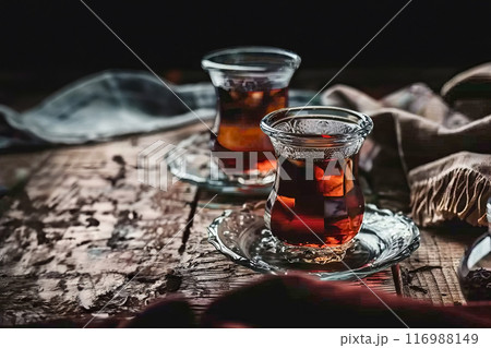 Two glasses with delicious Turkish tea on a wooden table in a cafe, healthy eating concept Two glasses with delicious Turkish tea on a wooden table in a cafe, healthy eating concept 116988149