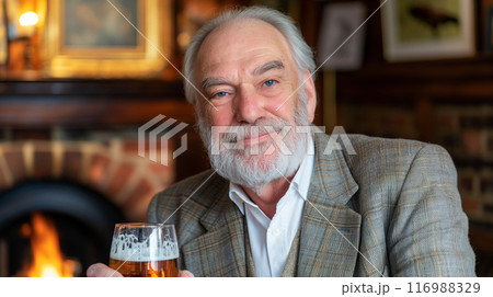 Portrait of an elderly man with a pint of beer in his hand, sitting in his favorite bar, lager advertising poster 116988329