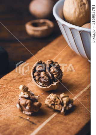 Cracked walnuts on cutting board 116992791
