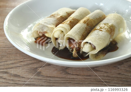 Peking roasted duck with slice cucumber and spring onion spring roll dreessing black sweet soy and chili sauce on plate 116993326