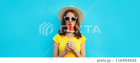 Summer portrait of stylish young woman with juicy lollipop or ice cream shaped slice of watermelon 116994688