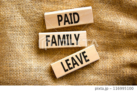 Paid family leave symbol. Concept words Paid family leave on wooden blocks. Beautiful canvas table canvas background. Business medical and paid family leave concept. Copy space. 116995100