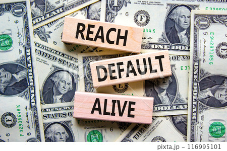 Reach default alive symbol. Concept words Reach default alive on wooden blocks on a beautiful background from dollar bills. Business, finacial and reach default alive concept. Reach default alive symbol. Concept words Reach default alive on wooden blocks on a beautiful background from dollar bills. Business, finacial and reach default alive concept. 116995101