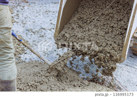 Concrete blocks delivered to construction site with foundation is ready for mounting wall of cement blocks 116995173