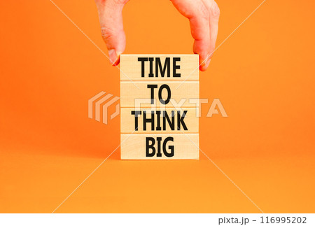 Time to think big symbol. Concept words Time to think big on beautiful wooden block. Beautiful orange table orange background. Businessman hand. Business and time to think big concept. Copy space. 116995202