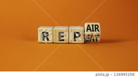 Repeat and repair symbol. Turned a wooden cube and changed the word repeat to repair. Beautiful orange table, orange background, copy space. Business, repeat and repair concept. 116995208