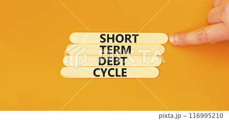 Short term debt cycle symbol. Concept words Short term debt cycle on wooden stick. Beautiful orange table orange background. Businessman hand. Business Short term debt cycle concept. Copy space. 116995210