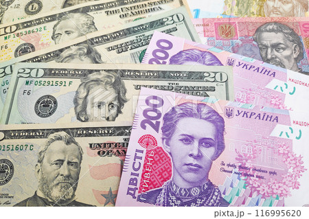 Stack of US Dollar and Ukrainian hryvnia 116995620