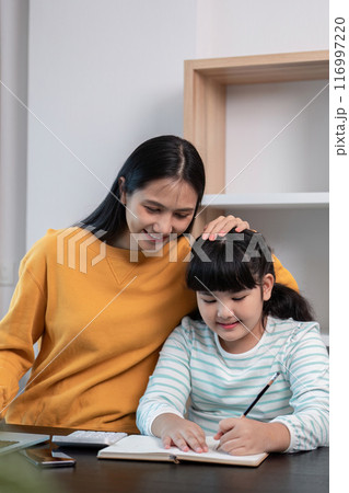 Mother and Child Working from Home, Smiling and Engaged in Learning Activities Together in a Modern Home Office Setting 116997220