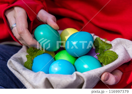 The Woman With a Basket of Vibrant Easter Eggs The Woman With a Basket of Vibrant Easter Eggs 116997379