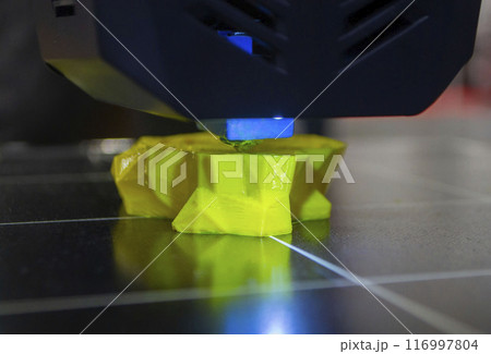 The process of printing an object with 3D printer. 3D printer printing a model from molten plastic. 3D printing. Robotic creation of mold form. Automated creation prototyping of 3D printers technology 116997804