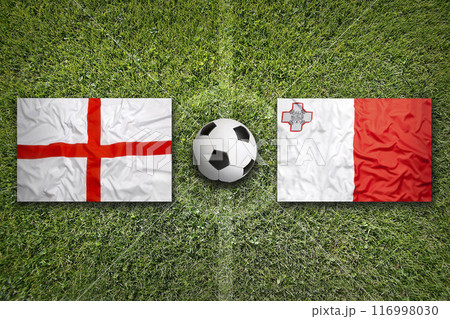 England and Malta flags on soccer field 116998030