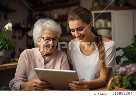 Tech Laughter Bonding Moments as an Adult Daughter Guides Her Elderly Mother in Tablet Use. created with Generative AI 116998294