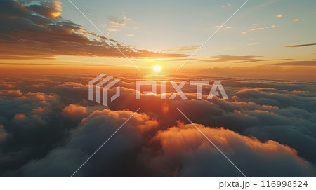 An aerial shot above beautiful sunset clouds with a golden sun illuminating the sky 116998524