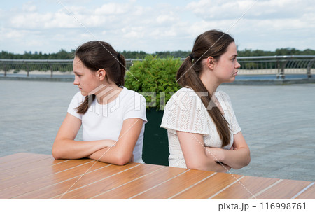 The girls look in different directions with resentment The girls look in different directions with resentment 116998761