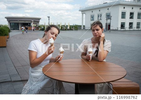 A woman looks at her friend with disapproval 116998762