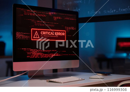 Background image of PC computer with emergency message of critical error on screen in red lights copy space 116999308