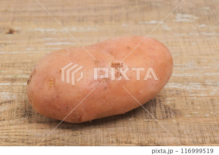 Fresh Organic Sweet Potato Placed Beautifully on a Wooden Surface for an Aesthetic Appeal 116999519