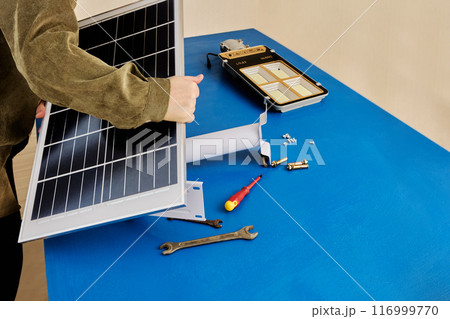 Installation of an autonomous, wireless solar street lamp, attaching solar panel to holder bracket 116999770