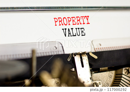 Property value symbol. Concept words Property value typed on beautiful old retro typewriter. Beautiful white paper background. Business property value concept. Copy space. 117000292