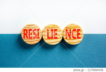 Resilience symbol. Concept word Resilience on beautiful wooden circles. Beautiful blue white background. Business resilience concept. Copy space. Resilience symbol. Concept word Resilience on beautiful wooden circles. Beautiful blue white background. Business resilience concept. Copy space. 117000436