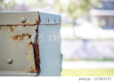 Rusted and peeling paint on an electrical transformer exposed to the elements. Rusted and peeling paint on an electrical transformer exposed to the elements. 117001575