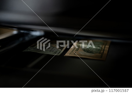 Using a copy machine to print forgery currency.  117001587