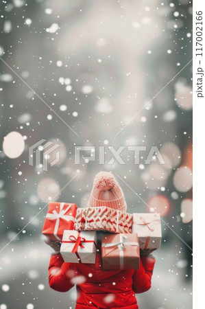 Woman Carrying Gift Boxes in Snowy Urban Setting During Winter Holiday Season 117002166