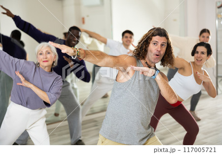 Group of adult people practices dance aerobics Group of adult people practices dance aerobics 117005721