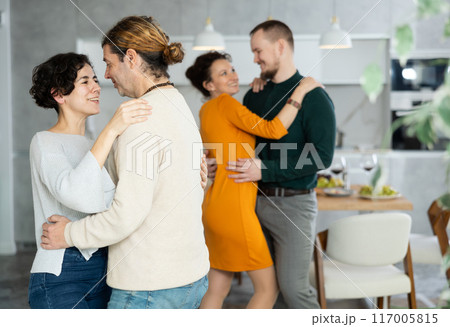Men and women dancing during house party. 117005815
