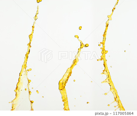 Fruit beverage water elements in line form . Fresh splashing and flowing jets, white background isolated freeze motion. Orange, lemon juice or oil lubricant splash, liquid gold yellow drink drops Fruit beverage water elements in line form . Fresh splashing and flowing jets, white background isolated freeze motion. Orange, lemon juice or oil lubricant splash, liquid gold yellow drink drops 117005864