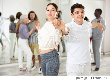 Confident couple of dancers enjoys a partner dance 117005964