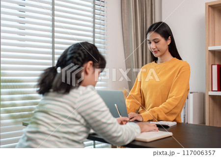 Mother and Child Working from Home Together in a Modern Home Office Setting with Natural Light 117006357