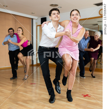 Young pair practicing Latino dance in dance studio 117006447