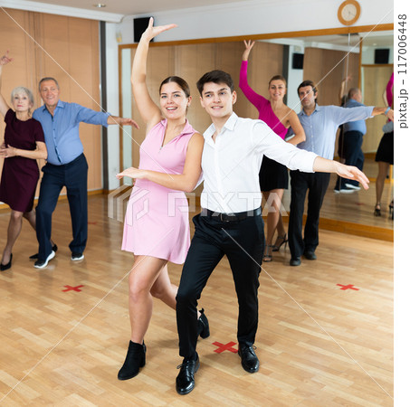 Young couple enjoying impassioned merengue in latin dance class Young couple enjoying impassioned merengue in latin dance class 117006448