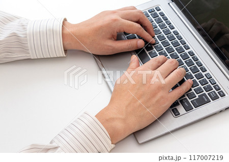 オフィスでパソコンのキーボードを打つ男性 117007219