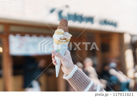 Woman showing Daibutsu or Buddha yogurt crepe, popular dessert in Kamakura, Kanakawa, Japan Woman showing Daibutsu or Buddha yogurt crepe, popular dessert in Kamakura, Kanakawa, Japan 117011821