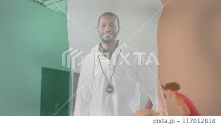 Image of flag of ireland over diverse basketball players on court 117012818