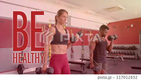 Image of be healthy text over diverse man and woman exercising in gym Image of be healthy text over diverse man and woman exercising in gym 117012832