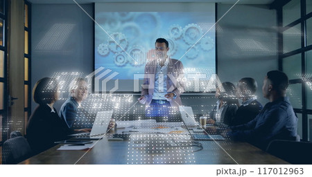 Image of binary coding data processing over diverse business people in office Image of binary coding data processing over diverse business people in office 117012963